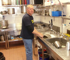 Dean in the kitchen at Mawson scrubbing pots