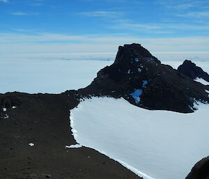 Mt Parsons is a dark rock peak rising out of the icy surrounds.