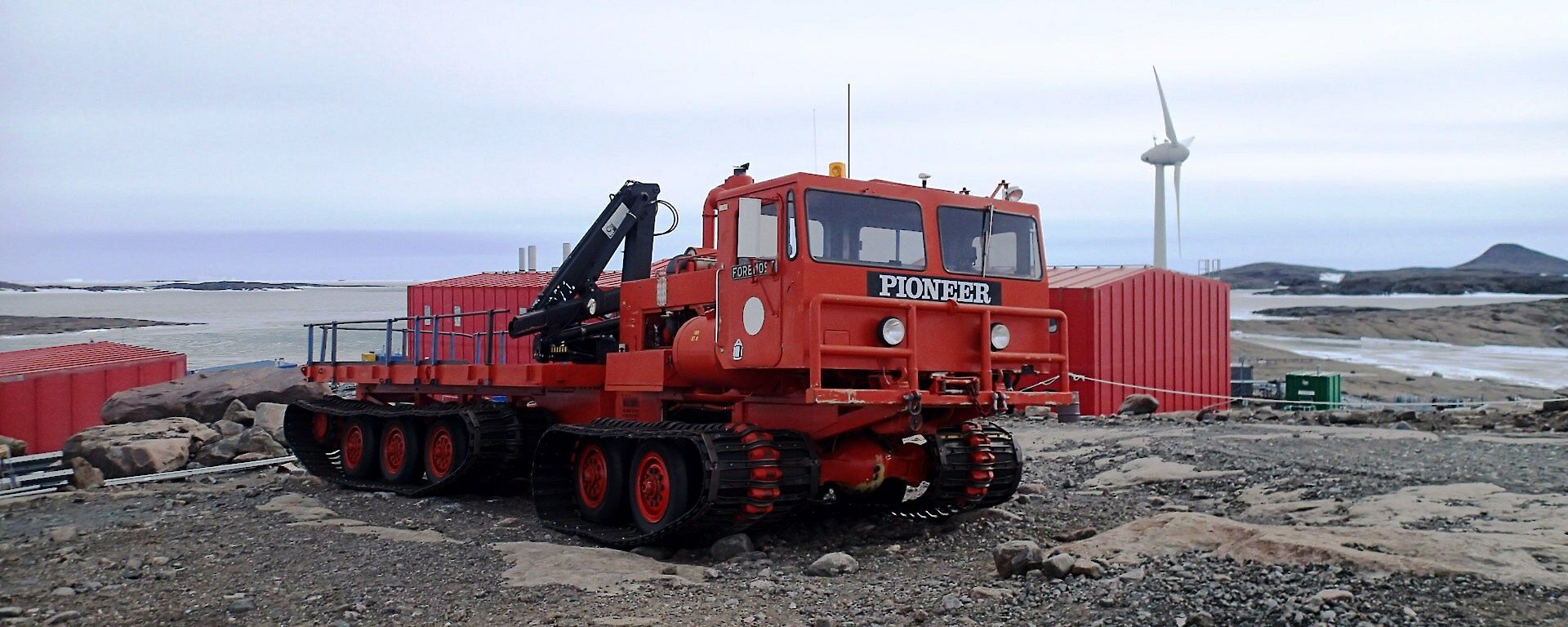 Old Pioneer bright orange oversnow vehicle