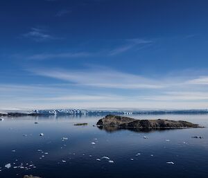 Boating at Mawson amongst the small rocks and bergie bits in still water.