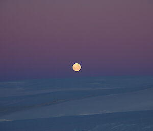 Mawson moonrise over an ice covered landscape