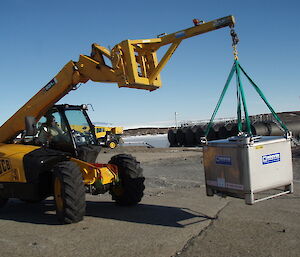 A small tractor delivers a fuel pod to the fuel farm