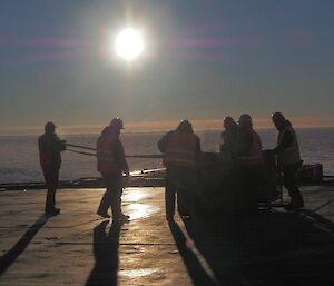 Workers and ship crew on the heli deck