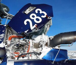 A helicopter turbine engine covered in snow