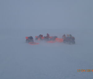 Setting up a quad survival bivvy tent between two Quad Bikes in a Blizzard