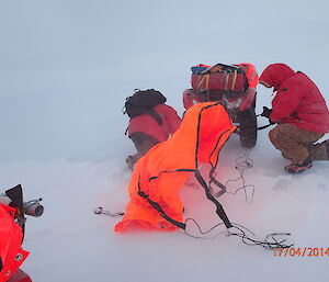Setting up a quad survival bivvy tent between two Quad Bikes in a blizzard