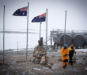 Lydia and Craig raising the Australian and Kiwi flags