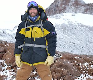 Photograph of Doctor James Chappell standing on a rocky and snowy landscape