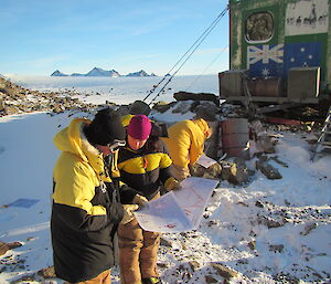 Expeditioners with map in hand preparing for a navigation exercise