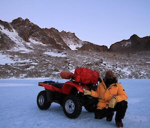 Expeditioner with his bivvy bag packed up and strapped onto his quad