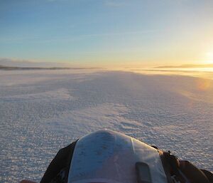 A view from the drivers seat out across the sea ice