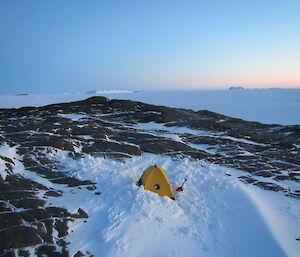 A small tent nearly buried in the snow on Bechervaise Island