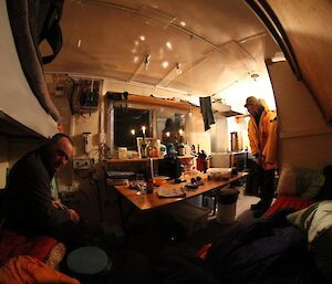 The expeditioners sitting inside Macey Hut
