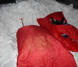 Two bivvy bags lying side by side in the sleeping pad