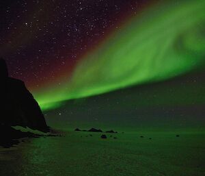 An aurora australis lights up the sky as you look back toward the David range from Rumdoodle