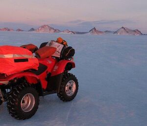 A lone quad bike parked on the plateau