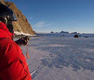 An expeditioner navigating with a compass on the plateau