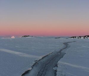 A tide crack in the sea ice approximately 1 meter wide