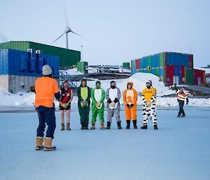 An expeditioner lining up to take a free kick in front of a wall of expeditioners dressed in Onesies