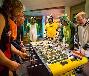 The expeditioners playing foosball in the bar