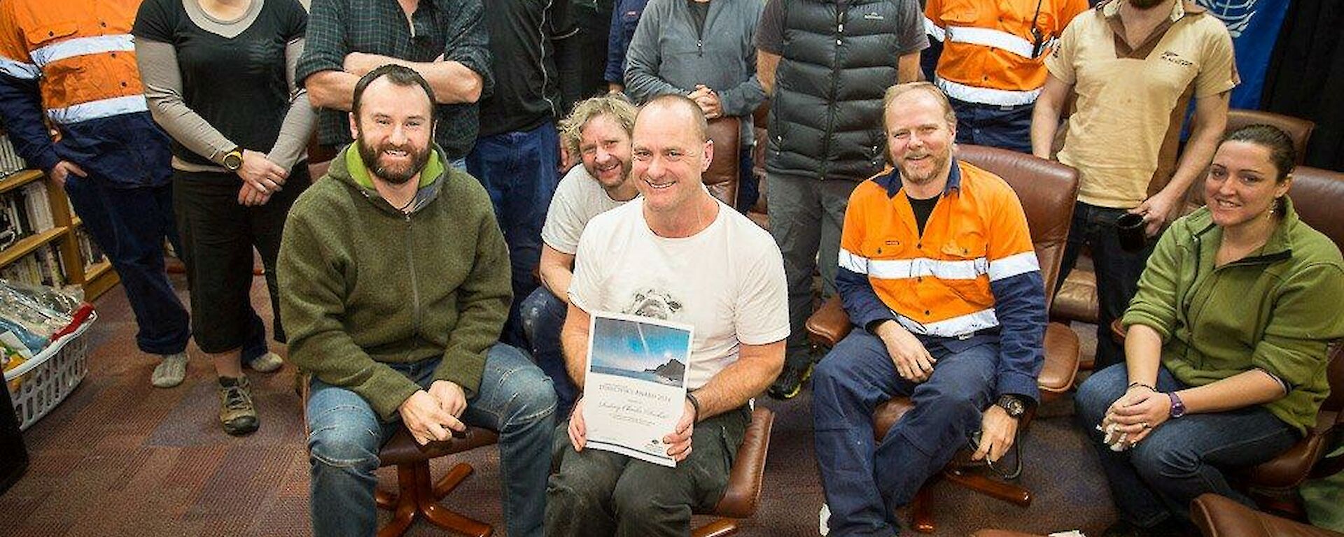 Mawson expeditioners gather for a photo with Rocket after he received his award