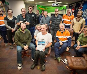 Mawson expeditioners gather for a photo with Rocket after he received his award