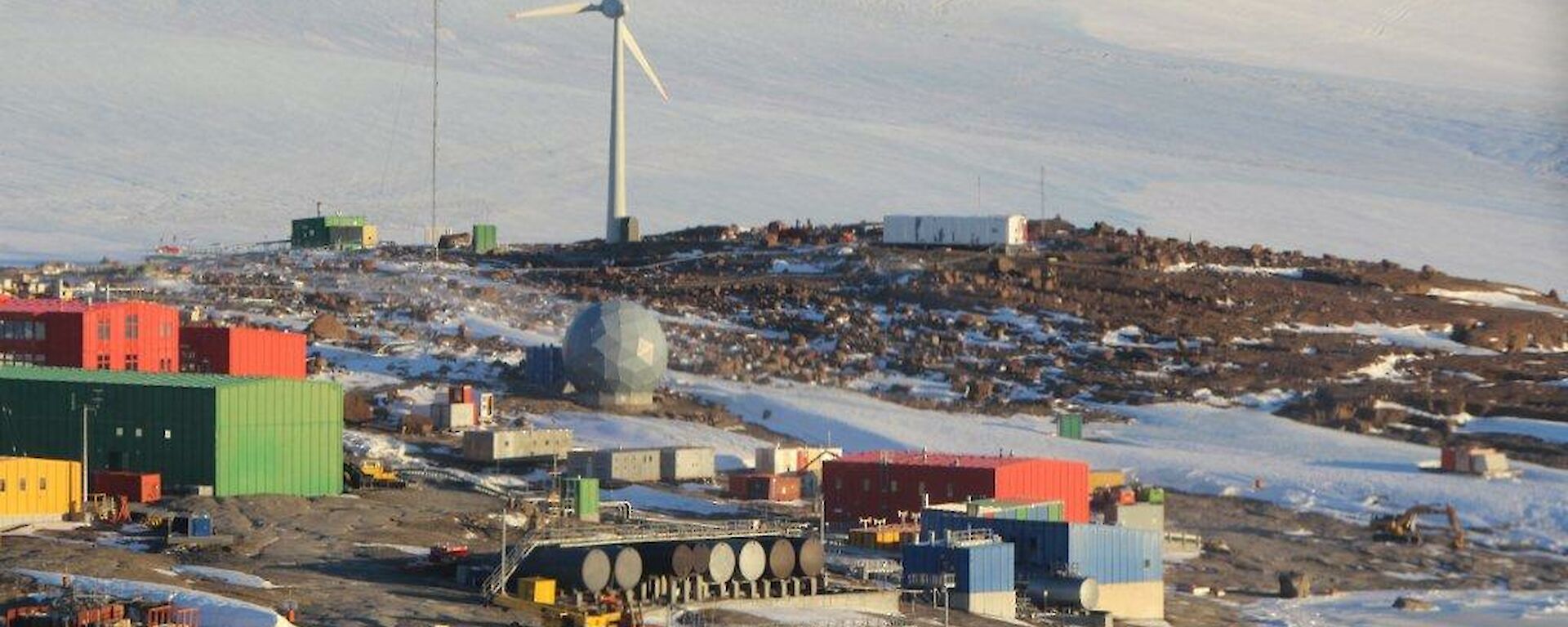 A view of Mawson station from a helicopter with the wind turbines in view