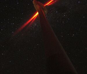 A wind turbine photographed at night
