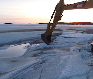 An excavator starts the process of digging the swimming hole