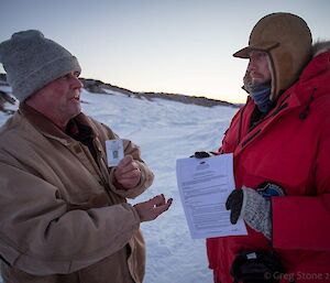 One of the expeditioners, who is also an inspector, checks an ASPA permit
