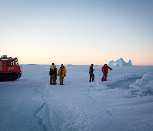 Expeditioners cautiously assessing a tide crack before crossing