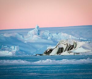 Sea ice with dark marking resembling chocolate topping on vanilla ice cream