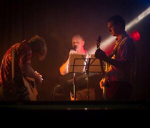 Two of the guitarists jamming along with the vocalist