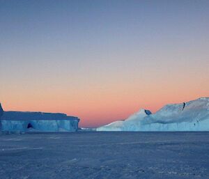 The happy place our minds take us to when it all goes pear shaped — icebergs frozen into the sea ice in a landscape daytime photo