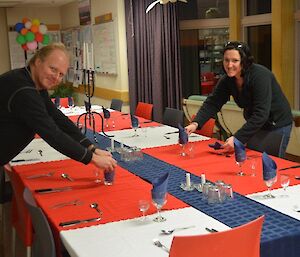 Two expeditioners setting the dining room table in preparation for Ewan’s 50th