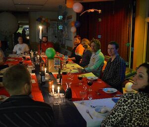 Expeditioners sitting at the dining room table celebrating Ewan’s 50th birthday