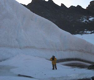 An expeditioner walking around the wind scourer