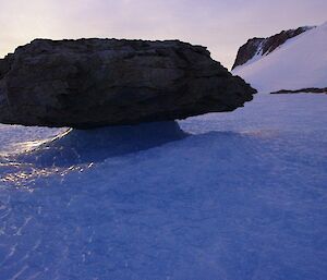 Hanging Rock — a rock perched on top of an ice spire