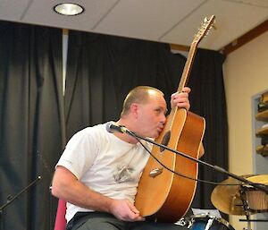 Rocket loves his guitar as he gives it a kiss