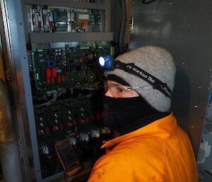 Electrician Dan checking the reference voltage for the exciter leakage current on the wind turbine