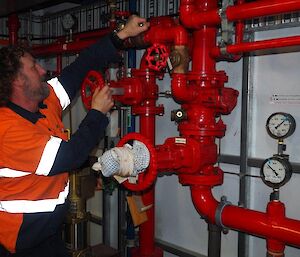 Plumber Ewan (and author) repairing leaks on the fire valve assembly