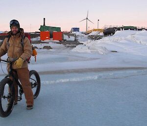 Doctor James on the mountain bike wearing heavy Carhartt overalls and jacket whilst carrying a survival pack — not your typical biking outfit?