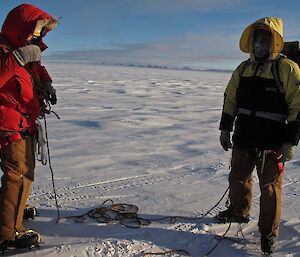 Two expeditioners tying into a rope so as to travel through an area suspected of having crevasses