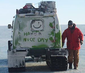 The green Hägglunds with, "Have a nice day" scribbled in the ice on the rear door
