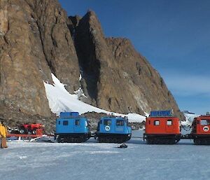 The orange Hägglunds hitched to the blue Hägglunds and ready to tow it away from the sled carrying the Quad