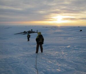 Expeditioners participating in crevasse travel training at the site of a Russian aircraft crash on the plateau