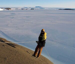 An expeditioner abseiling off the edge of West during a search and rescue exercise