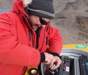 Andy repairing a radio repeater in the field
