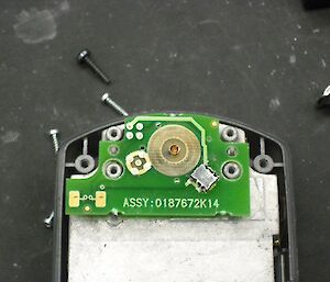 Parts of a satellite telephone as it is being repaired