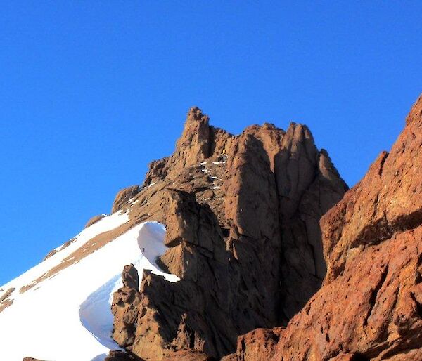 A perfect day for climbing with the sun shining down on a climber as they near the summit of Mt Hordern’s East Peak